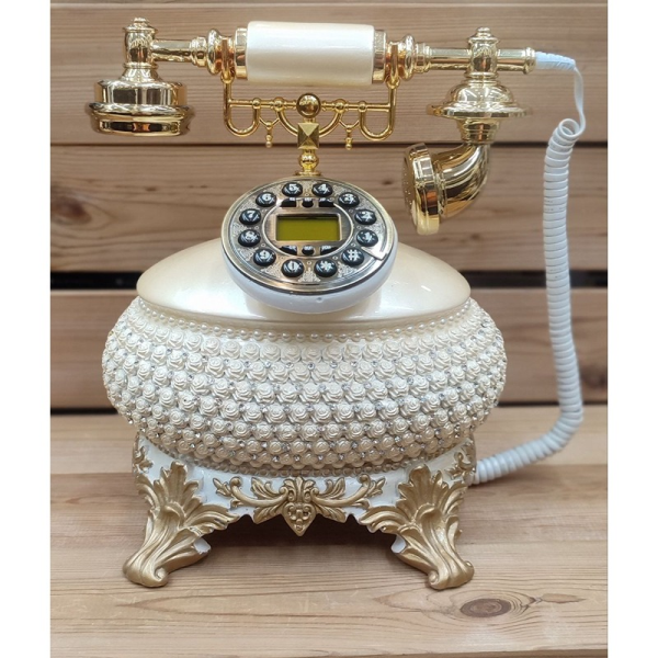 تلفن سلطنتی رومیزی رایکا مدل 310، تلفن سلطنتی با طراحی طرح نقش برجسته روی بدنه تلفن، شماره گیر دکمه ای و دارای کالر آیدی، دکوری شیک و جذاب مناسب منزل و محل کار| رنگ سفید طلایی