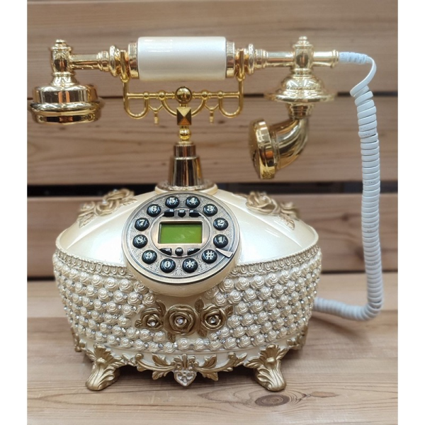 تلفن سلطنتی رومیزی رایکا مدل 340، تلفن سلطنتی با طراحی طرح نقش برجسته روی بدنه تلفن، شماره گیر دکمه ای و دارای کالر آیدی، دکوری شیک و جذاب مناسب منزل و محل کار| رنگ سفید طلایی