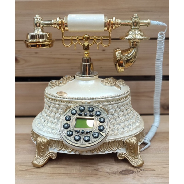 تلفن سلطنتی رومیزی رایکا مدل 320، تلفن سلطنتی با طراحی طرح نقش برجسته روی بدنه تلفن، شماره گیر دکمه ای و دارای کالر آیدی، دکوری شیک و جذاب مناسب منزل و محل کار| رنگ سفید طلایی