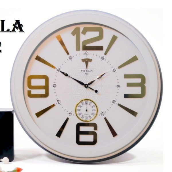 ساعت دیواری تسلا مدل X22، ساعت دیواری دو موتوره سایز 60 با طراحی ساده، دارای اعداد بزرگ و برجسته لاتین، دارای موتور روانگرد درجه یک، رنگ سفید